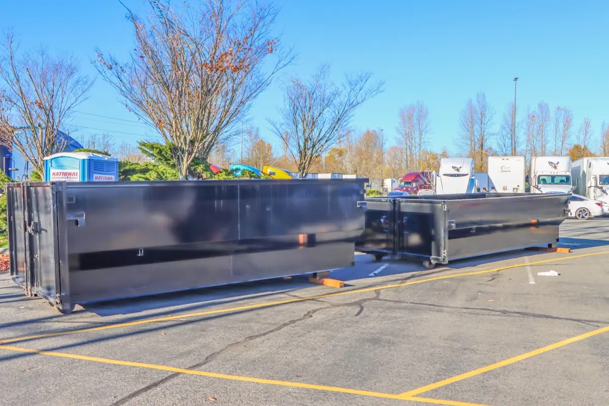 Professional dumpster rental service with roll-off container on residential driveway in South Park